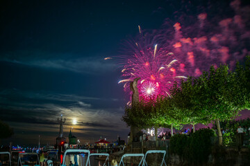 People watching beautiful fireworks at Constance lake night festival photographed from the harbor...