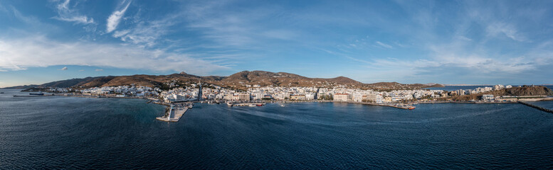 Tinos island Hora town Cyclades Greece. Aerial drone panoramic view of harbor, sea blue sky. Banner