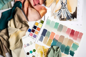 Generative AI illustration of fashion clothes sketches near fabric swatches, color board, palette and color pencil in workshop