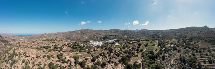 Fototapeta na wymiar Greece. Tinos island Cyclades. Aerial panoramic view of Volax village, granite stone background.