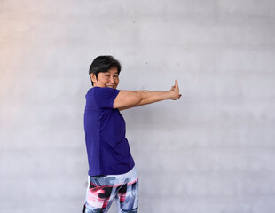 Old lady clasp hands and twist body to the right side,for stretching body before exercise