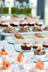 a table topped with cups filled with desserts. hotel conference coffee break idea. table with snacks