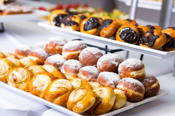 a table topped with lots of different types of donuts. hotel conference coffee break idea