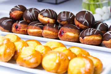 a table topped with lots of different types of donuts. hotel conference coffee break idea