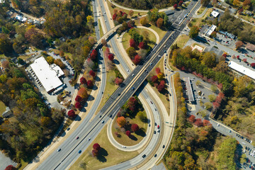 Aerial view of american freeway intersection with fast moving cars and trucks. USA transportation...