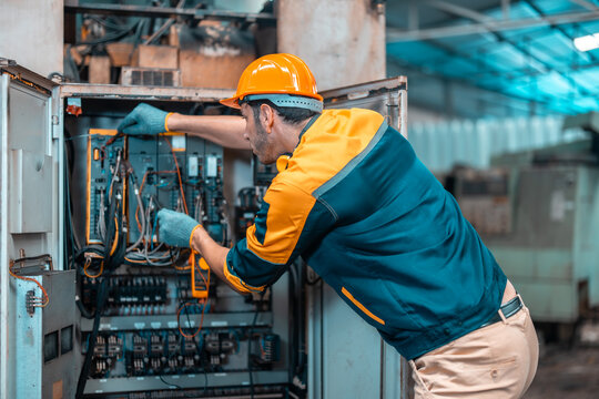 Electrical technician tests wiring, polarity, grounding, voltages and performs electrical maintenance using hand tools that involve clamp meter, screwdriver, and cutter. The foreman's routine tasks.