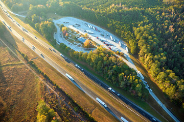 Aerial view of big rest area near busy american freeway with fast moving cars and trucks....