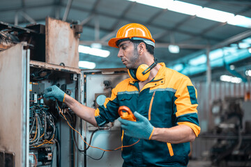 Electrical technician tests wiring, polarity, grounding, voltages and performs electrical maintenance using hand tools that involve clamp meter, screwdriver, and cutter. The foreman's routine tasks.