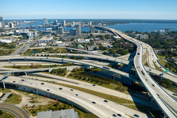American freeway intersection with fast driving cars and trucks. View from above of USA transportation infrastructure