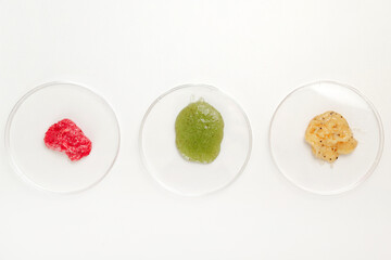 Three Petri Dishes with Color Cosmetics Scrub on white Background, Laboratory Test, flat lay.