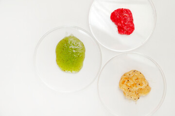 Three Petri Dishes with Color Cosmetics Scrub on white Background, Laboratory Test, flat lay.