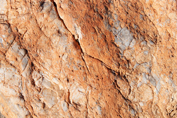 Texture of uneven orange stone