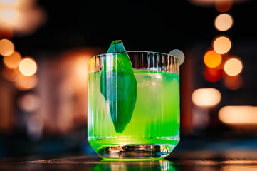 alcohol cocktail in a glass stands on a table in a bar or restaurant