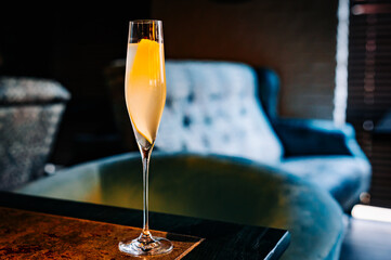 alcohol cocktail in a glass stands on a table in a bar or restaurant