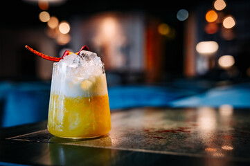 alcohol cocktail in a glass stands on a table in a bar or restaurant