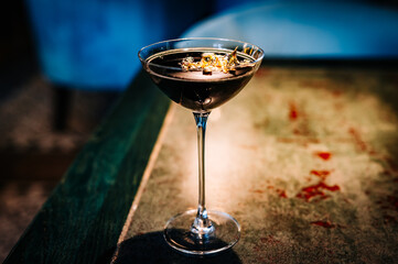 alcohol cocktail in a glass stands on a table in a bar or restaurant