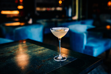 alcohol cocktail in a glass stands on a table in a bar or restaurant