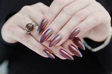 Beautiful woman's hand with long nails and multicolored nail polish