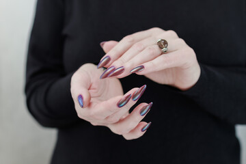 Beautiful woman's hand with long nails and multicolored nail polish
