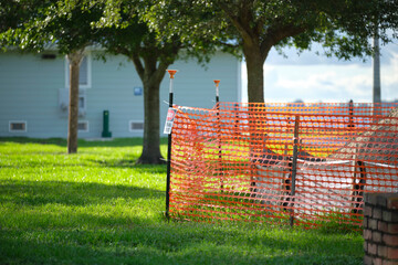 Restriction plastic mesh fence at industrial construction site. Protective barrier for pedestrians safety