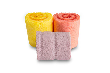 Three homemade roll cakes of different color isolated on white background with clipping path.