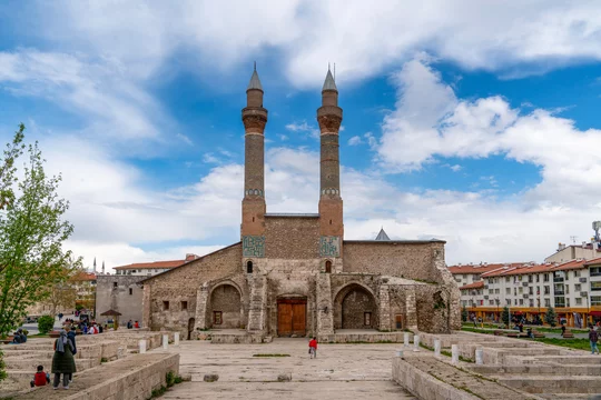 Sivas, Turkey - May 7 2023: Double Minaret Madrasah (Cifte minareli medrese in Turkish) with visitors around