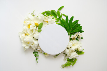 Round frame wreath with fresh flower buds, branches and leaves isolated on white background. flat lay, top view.