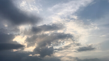 The sky’s overcast. The sun's rays make their way cloudy overcast sky that's about to start raining.