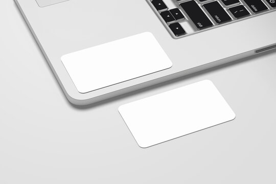 Business Card Mockup over a Laptop keyboard on a White background