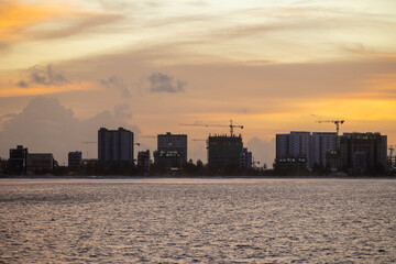 Huge buildings with sunset or sunrise, with sky and sea in a tropical island | Hiyaa flat of Maldives
