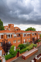 Dark and dramatic storm skies loom over the townhouses in central Spain.