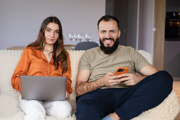 social network, friends and gadgets. Work-life balance. A girl and a boy using laptop and phone. Wokring from home.