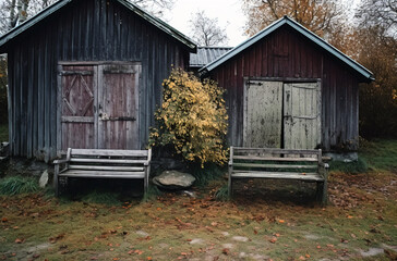 A couple of benches facing a wooden shed