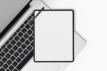 Mockup of a tablet screen over a laptop keyboard on a white background