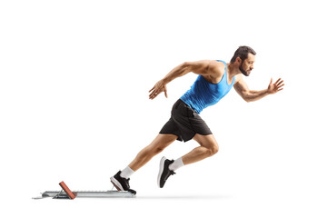 Full length profile shot of a male athlete on starting blocks