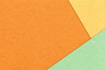 Texture of craft orange color paper background with light yellow and green border. Vintage abstract...