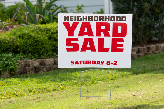 Neighborhood Yard Sale Sign placed in yard
