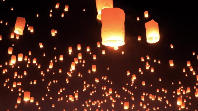 Thousands of glowing sky lanterns are released into the night sky to wish for good luck as part of a lantern festival.