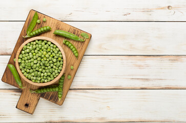 Composition with fresh green peas on wooden background, top view