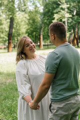 portrait of a couple in love a man and a pregnant woman are hugging, waiting for a new addition to the happy family