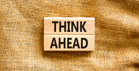 Think ahead symbol. Concept words Think ahead on wooden blocks on a beautiful canvas table canvas...