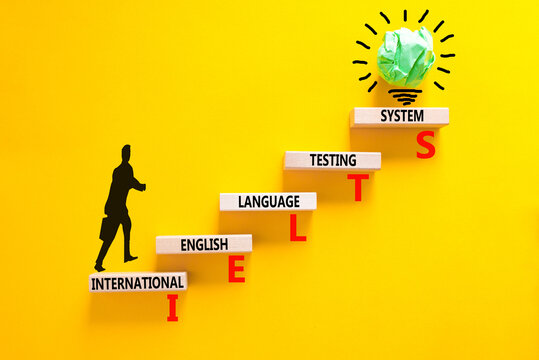 IELTS symbol. Concept words IELTS international english language testing system on wooden block. Beautiful yellow background. Business IELTS international english language testing system concept.