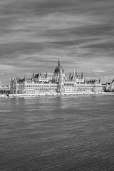 Fototapeta premium Budapest, Hungary: The Hungarian Parliament Building, seat of the National Assembly of Hungary on the Danube river waterfront in black and white