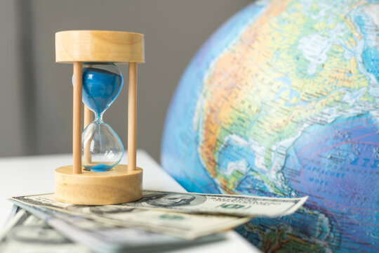 World globe with laptop and hourglass. Online business and globalisation theme