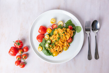Harissa spiced tomato pastawith spinach and mixed tomatoes