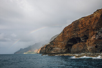 Rainbow over the mountains of the NaPali coast on the island of Kauai, Hawaii from a sunset cruise