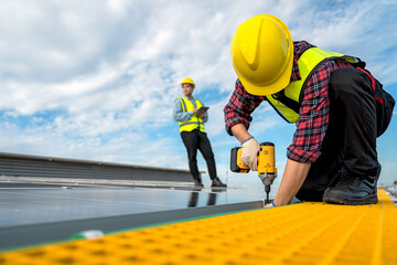 Technicians are installing solar panels on factory roof, with Asian engineer supervising, supervising installation. Installation of solar panels to transform solar energy into sustainable electricity.