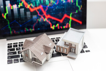 Small toy house is lies on money, bank form.