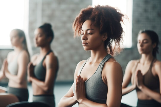 Group of mixed race women practicing yoga in the gym close up