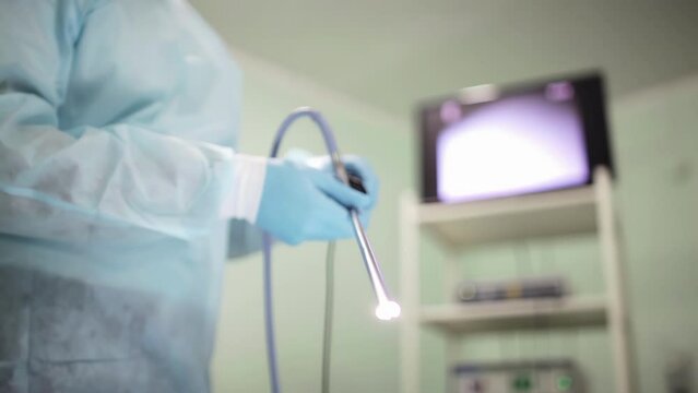 Surgeon meticulously readies the camera probe and equipment, ensuring precision and readiness for a surgical procedure.
